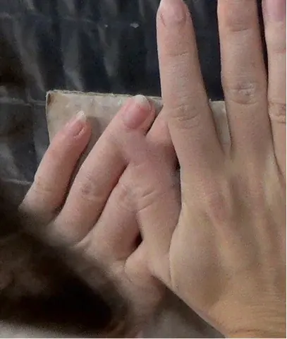 Mans apretant un bloc de fang contra la paret